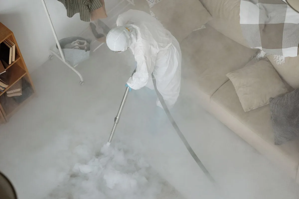 Biohazard cleanup technician in protective equipment, Northeast Overtown, Miami, FL